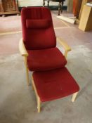 A beech framed armchair in red fabric with stool