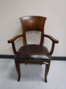 An oak leather upholstered armchair