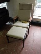 A Danish teak high backed armchair with stool