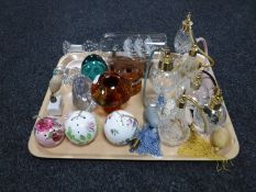 A tray of a collection of glass and china perfume bottles, china pomander, glass paperweights,