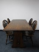 An oak refectory dining table and four wheel back chairs