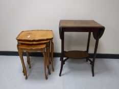 A nest of three pie crust edge tables and an occasional table