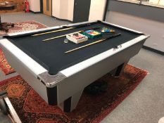 A contemporary 6' pool table with a boxed set of Aramith balls,