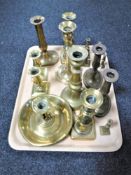 A tray of assorted brass candlesticks