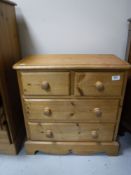 A pine four drawer chest