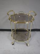 A brass cheval mirror and a serving trolley
