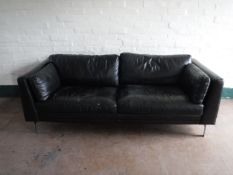 A black leather two seater settee on chrome legs