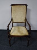 A mahogany armchair in a gold fabric