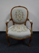 A carved walnut framed salon armchair