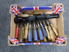 A box of assorted work working chisels and a flashlight