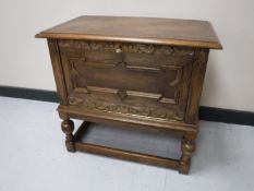 An early 20th century carved oak cabinet