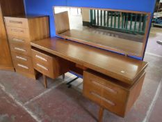 A teak G Plan knee hole dressing table and mirror
