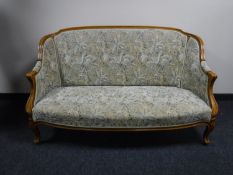 An early 20th century carved walnut framed settee