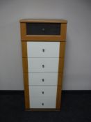 A narrow pine effect six drawer chest