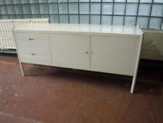 A painted double door sideboard fitted four drawers