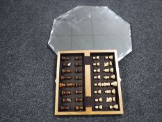 An early 20th century unframed mirror and a travel chess set