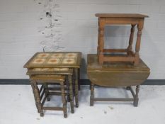 A nest of three oak tiled top tables,