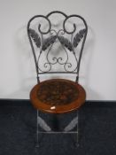 A folding metal chair with pine seat