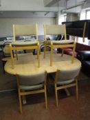 A pine oval dining table and six chairs