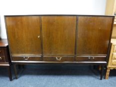 A mid 20th century walnut triple door sideboard