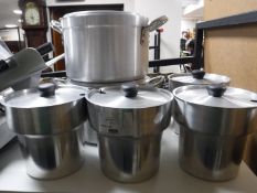 Two aluminium lidded cooking pots together with four bain marie pots with lids