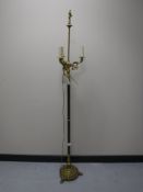 An ornate brass standard lamp