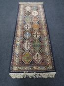 A fringed runner of geometric design on blue ground