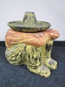 A contemporary planter in the form of a sleeping Mexican