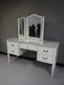 A contemporary knee hole dressing table with mirror and a pair of matching bedside stands
