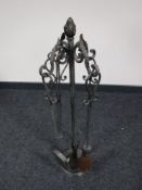 A four piece companion set on stand