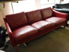 A late 20th century Danish red leather three seater settee