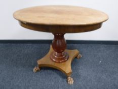 A 19th century mahogany oval pedestal table on paw feet
