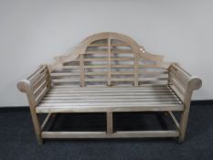 A plantation teak scroll arm garden bench