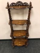 A Victorian inlaid walnut four-tier what not,