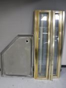 A brass framed shower enclosure and shower tray