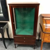 A glazed mahogany display cabinet fitted two drawers beneath,