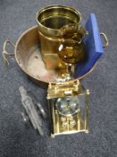 An antique copper twin handled pan containing anniversary clock, brass stick stand,