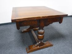 An early 20th century oak pull out table