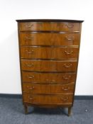 A mid 20th century walnut seven drawer chest