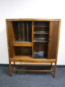 A mid 20th century walnut shutter door cocktail sideboard