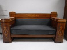 A late 19th century inlaid mahogany hall settee fitted with cupboards