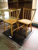 A low coffee table and a pair of kitchen chairs