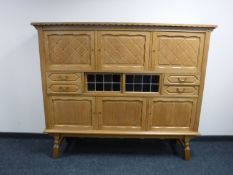 A blonde oak sideboard fitted six cupboards