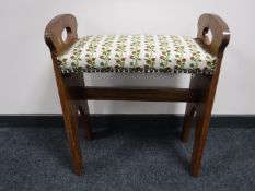 An Arts and Crafts upholstered stool