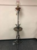 An Arts and Crafts copper and wrought metal standard lamp with etched glass shade,