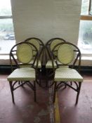 Four wicker and bamboo dining chairs