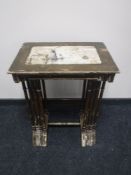 A nest of four hand painted early 20th century tables depicting Dutch scenes