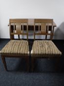 An inlaid mahogany dining table and two chairs