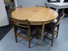 A circular mid twentieth century teak extending dining table,