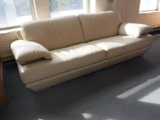 A cream leather three seater settee CONDITION REPORT: Some minor scuffs but overall